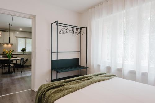 a bedroom with a bed and a dining room at Residenza al Parco in Gorizia