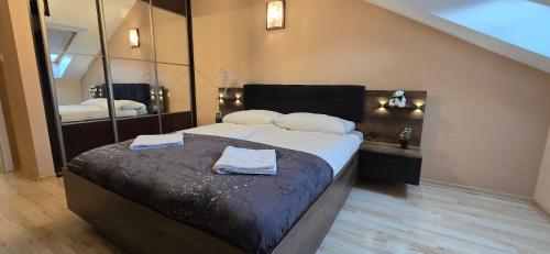 a bedroom with a bed with two towels on it at Apartament Nuldenovski Resort Grzybowo in Grzybowo