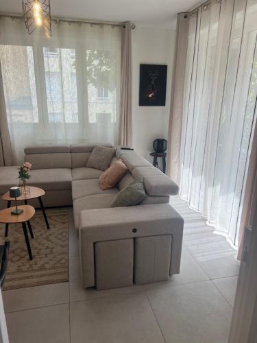 a living room with a couch and a table at Le dunkerquois 3 proximité du centre-ville et plage in Dunkerque