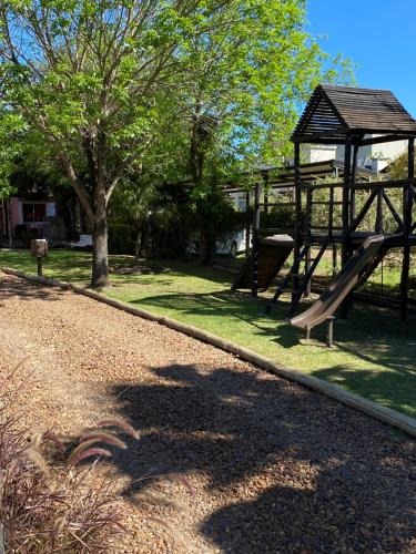a park with a slide and a gazebo at Cabañas Peumayen in Colón