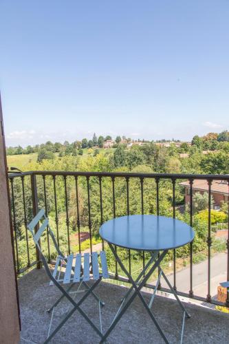a table and chairs on a balcony with a view at Casa Graziella- appartamenti vacanze in Portacomaro