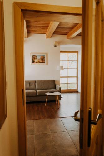 a living room with a couch and a table at Penzion Fořtovna in Častrov