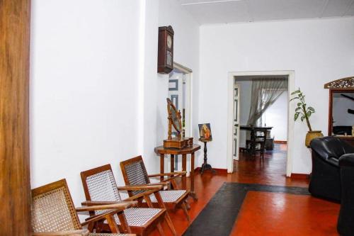 a living room with chairs and a couch at Ankelipitiya in Kotadeniyawa