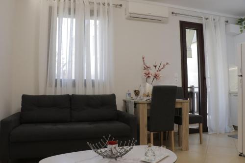 a living room with a couch and a table at Helen's Little Castle free private parking in Thessaloniki