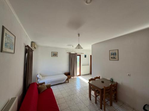 a living room with a couch and a table at Zac & Georgio Studios in Amoudara Herakliou