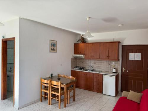 a kitchen with a table and a small kitchen with a table and chairs at Zac & Georgio Studios in Amoudara Herakliou