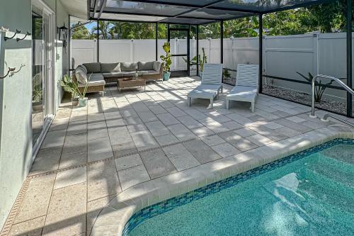 a patio with a pool and chairs and a couch at Lounging Palms Estate in Fort Myers