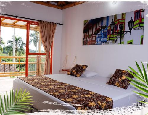a bedroom with two beds and a painting on the wall at Hotel Campestre La Aldea Cabaña Pijao in Montenegro