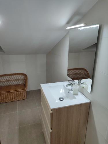 a bathroom with a sink and a mirror at O fogar da Bernardita in Redondela