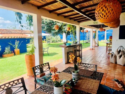 a patio with a table and chairs with a view of the ocean at Pancha Mama Hotel Boutique in Villa de Leyva