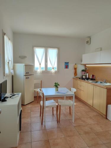 a kitchen with a table and a table and chairs at Nice apartments lake view & free parking in Pastrengo