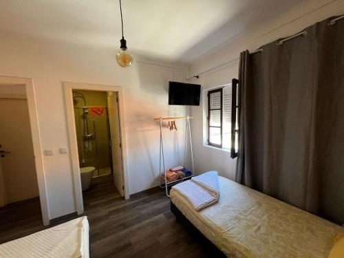 Ένα ή περισσότερα κρεβάτια σε δωμάτιο στο Guest House D'Avenida