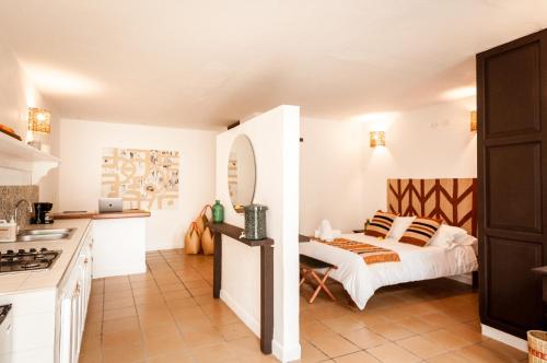 a white kitchen with a bed in a room at Pancha Mama Hotel Boutique in Villa de Leyva