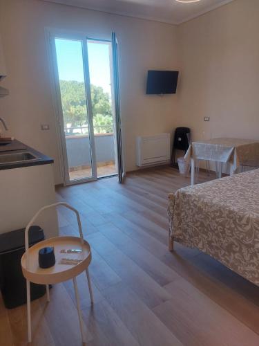 a hotel room with a bed and a table and a tableablish at Alcantara Suites in Trapani