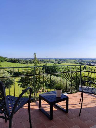 a patio with a table and chairs and a view at Nice apartments lake view & free parking in Pastrengo