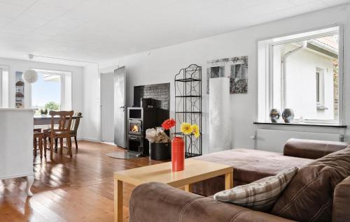 a living room with a couch and a table at Three-Bedroom Apartment In Broager in Broager