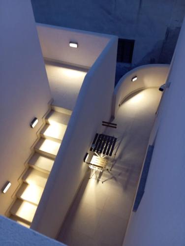 a stairway with a bench in a building with lights at Maruzza Home in Favignana