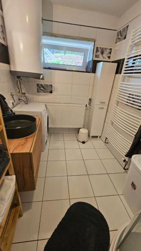 a small kitchen with a sink and a window at Farma u lesa in Hlinsko