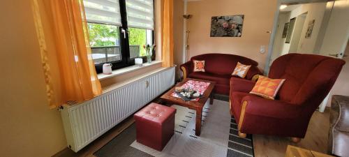 a living room with two chairs and a table at FeWo Harz Haennig 1 in Wieda