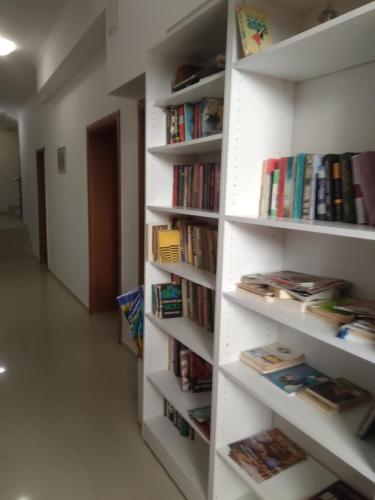 a book shelf filled with lots of books at Apartments Dani in Pomorie
