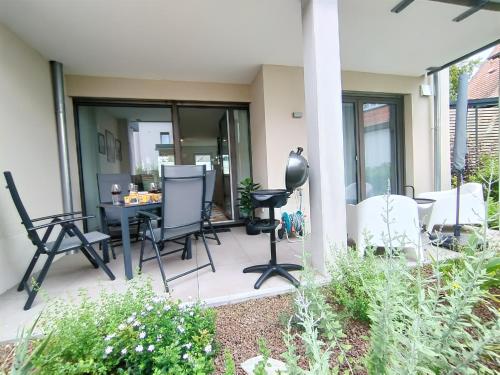 a patio with chairs and a table on a house at Bright Apartment für bis zu 5 Erlangen in Erlangen