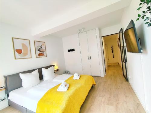 a bedroom with a bed with two towels on it at Bright Apartment für bis zu 5 Erlangen in Erlangen