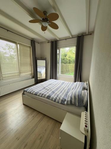 a bedroom with a bed and a ceiling fan at The Horse Farm in Garnwerd