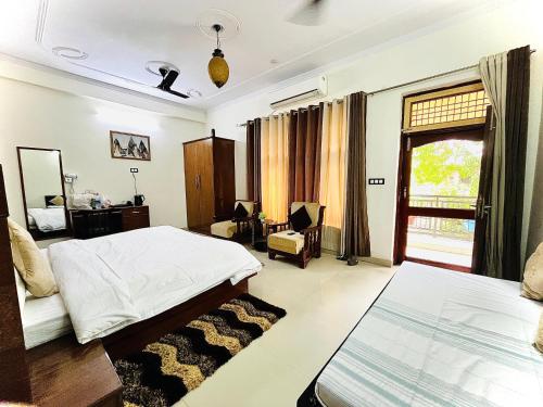 a bedroom with two beds and a window at Alibaba’s Indiana Homestay in Agra