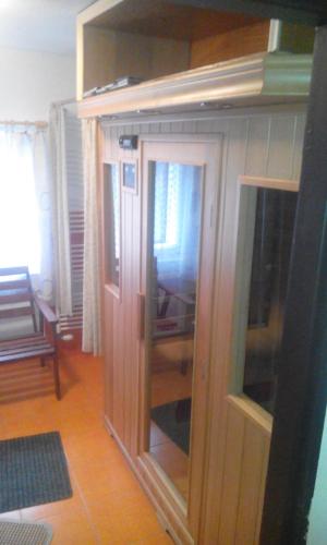 a room with a wooden cabinet with glass doors at Maršovská Rychta in Nové Město na Moravě