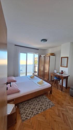 a large bed in a room with a large window at Apartment Lukovo - Puskaric in Lukovo