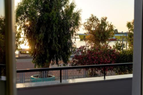 a view from a window of a park with a tree at 2 Brother's Suites I in Zakynthos Town