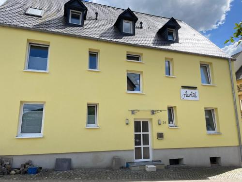 a yellow house with a gray roof at Auszeit in Zeltingen-Rachtig