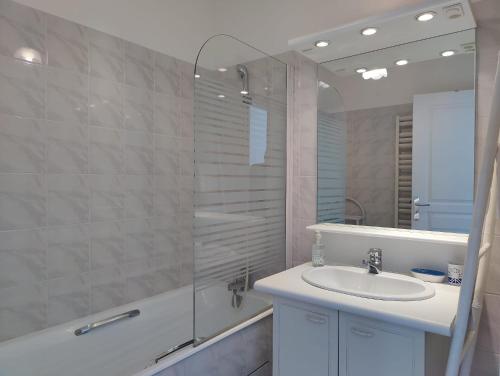 une salle de bain avec un lavabo et une douche avec un miroir dans l'établissement Côté Océan, Vue Mer et Terrasse, à La Rochelle