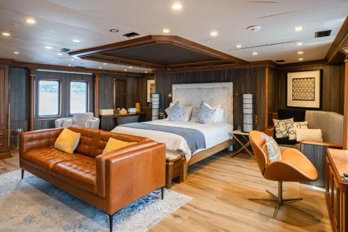 a bedroom with a bed and a couch at iRama Luxury Superyacht 6 Cabins & Hot Tub & Water Toys in Cannes