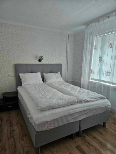 Ένα ή περισσότερα κρεβάτια σε δωμάτιο στο Suncity 2 apartamentai