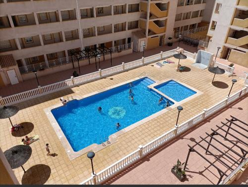 an overhead view of a swimming pool in a building at Ático Calblanque in Mar de Cristal