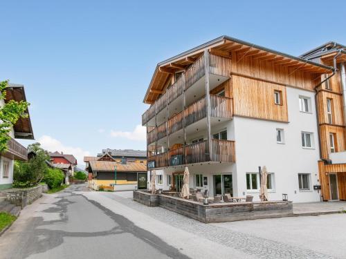 an apartment building with a wooden roof on a street at Apart33 Top 1-28 in Haus im Ennstal