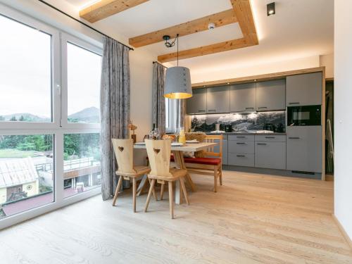 a kitchen and dining room with a table and chairs at Apart33 Top 1-28 in Haus im Ennstal