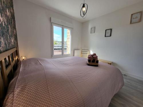 a bedroom with a large bed with a teddy bear on it at L'Antre des Généraux in Percy