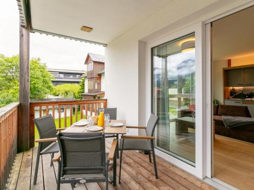 a patio with a table and chairs on a deck at Apart33 Top 1-27 in Haus im Ennstal
