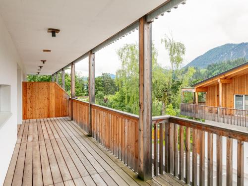 a large wooden balcony with a view of the mountains at Apart33 Top 1-27 in Haus im Ennstal
