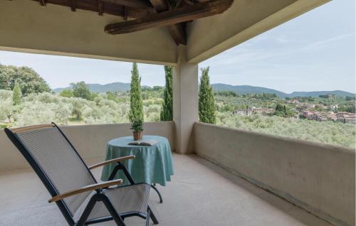 a table and a chair on a balcony with a view at Nice Home In Torri In Sabina With Wifi in Torri in Sabina