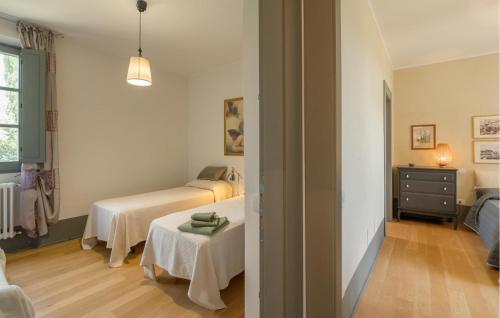 a room with two beds and a table in it at Nice Home In Torri In Sabina With Wifi in Torri in Sabina