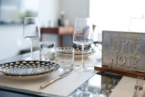 a table with wine glasses and a sign on it at Lovely 1 BD in West Hollywood in Los Angeles