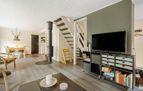 a living room with a television and a staircase at Beautiful Home In Give With Kitchen in Give