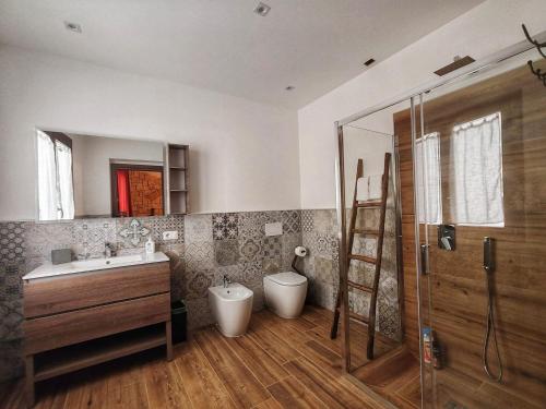 a bathroom with a sink and a shower and a toilet at S'Arrioleddu in Muravera