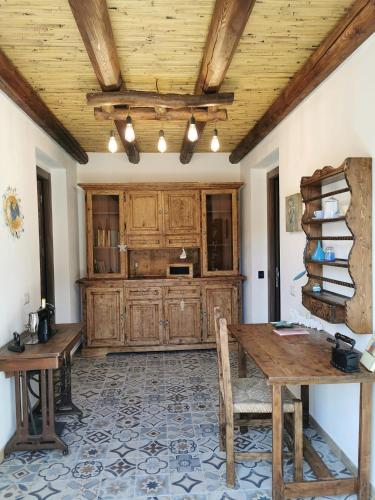 a dining room with wooden cabinets and a table at S'Arrioleddu in Muravera