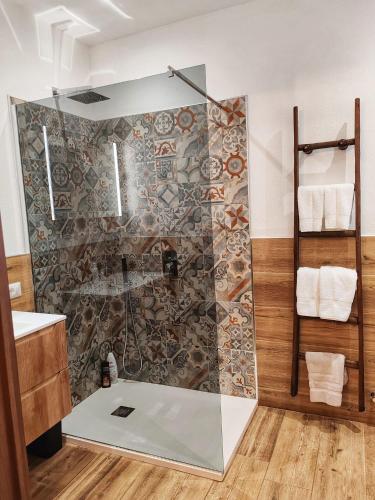 a bathroom with a shower with a glass door at S'Arrioleddu in Muravera