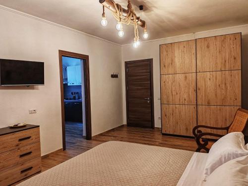 a bedroom with a bed and a dresser and a tv at S'Arrioleddu in Muravera