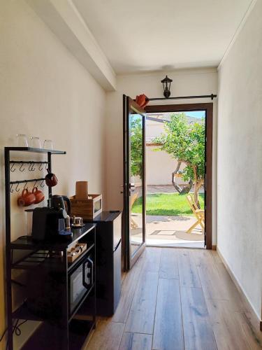 an empty room with a door open to a yard at S'Arrioleddu in Muravera